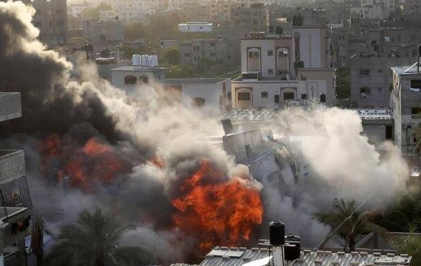 Smoke and fire rise from an explosion caused by an Israeli airstrike targeting a building in Gaza